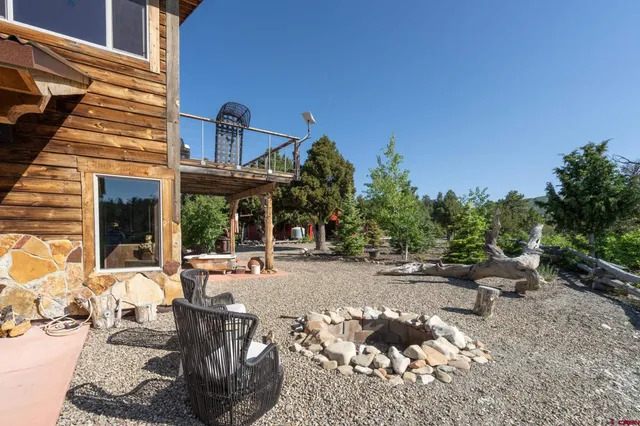 a view of a backyard with sitting area