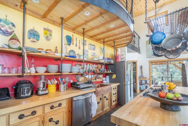 a kitchen with lots of counter top space and wooden floor