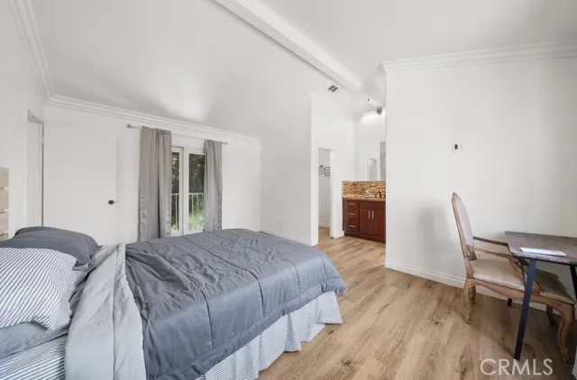 a spacious bedroom with a bed and a chair