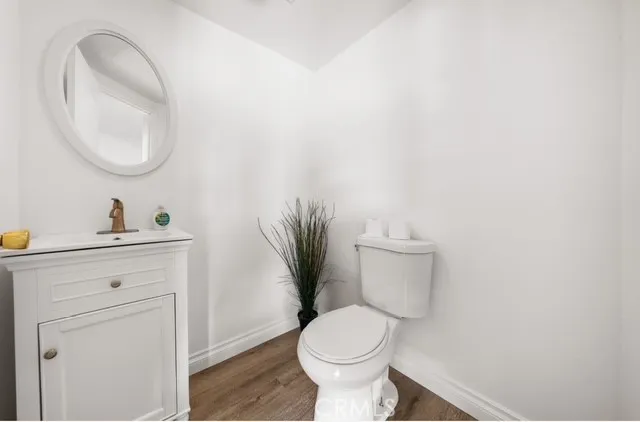 a bathroom with a toilet a sink and a mirror