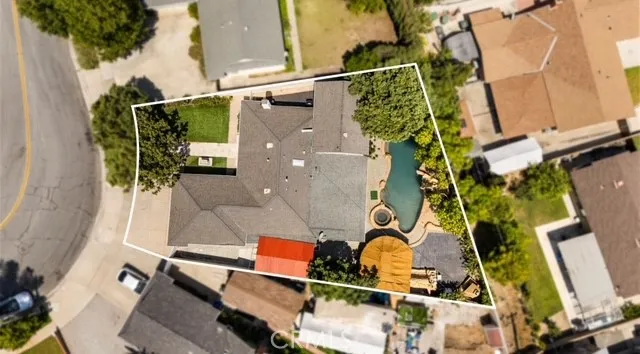 an aerial view of a house with a backyard
