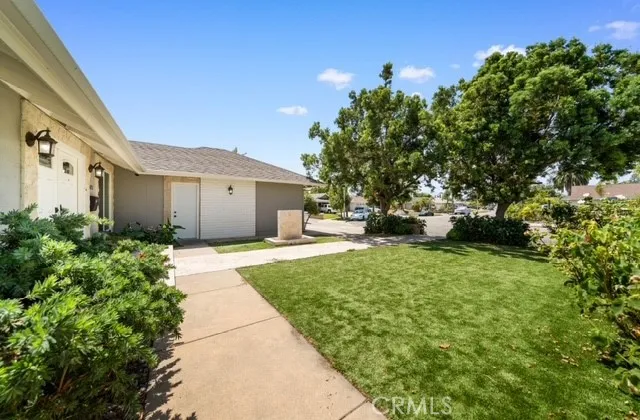a front view of a house with a garden and trees