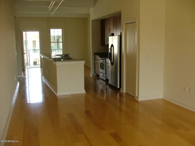 a kitchen with granite countertop a sink and cabinets