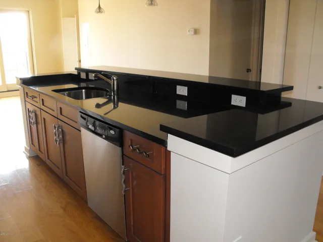 a kitchen with stainless steel appliances granite countertop a refrigerator stove and microwave