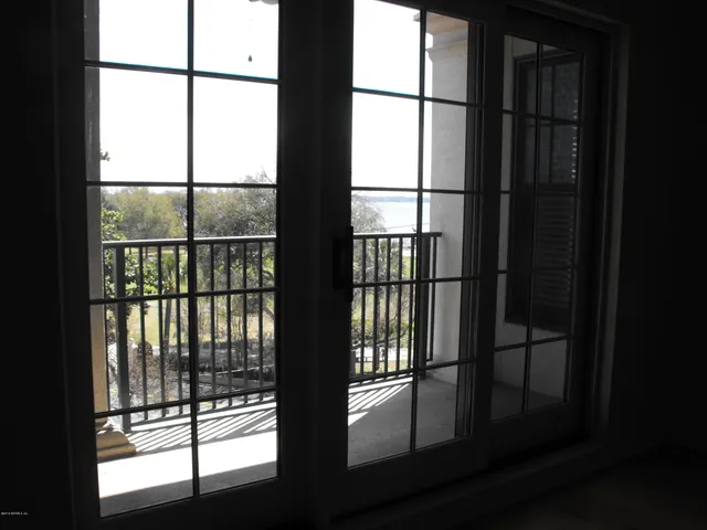 a view of wooden floor and a window in an empty room