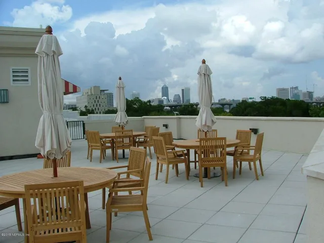 a view of a dinning table and chairs in the patio