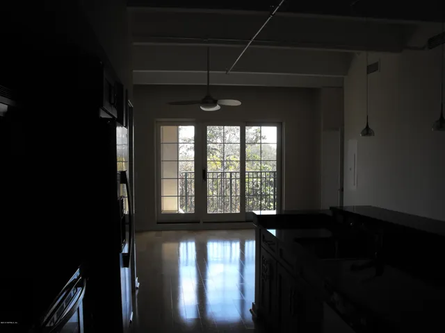 a kitchen with granite countertop a refrigerator and a sink