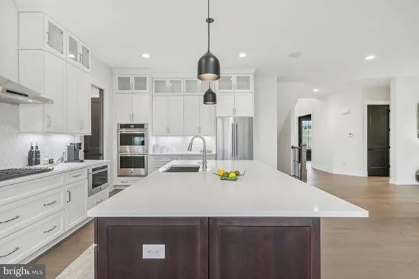 a kitchen with a sink a stove and chairs