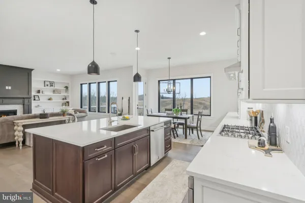 a kitchen with a sink stove and white cabinets
