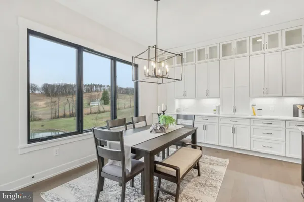 a dining room with furniture a chandelier and a rug