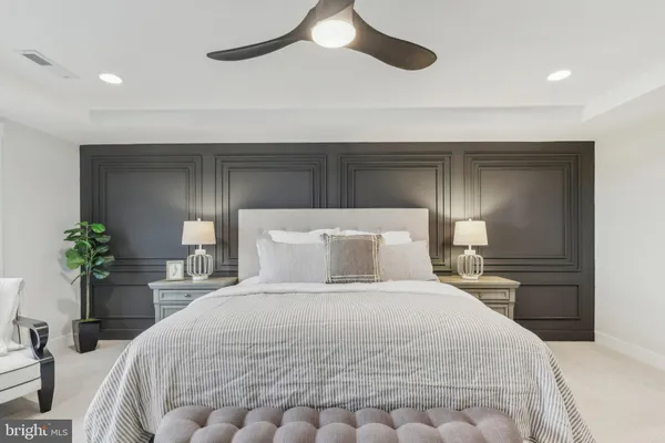 a bedroom with a bed and lamps