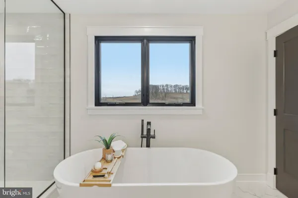 a white bath tub sitting next to a white sink