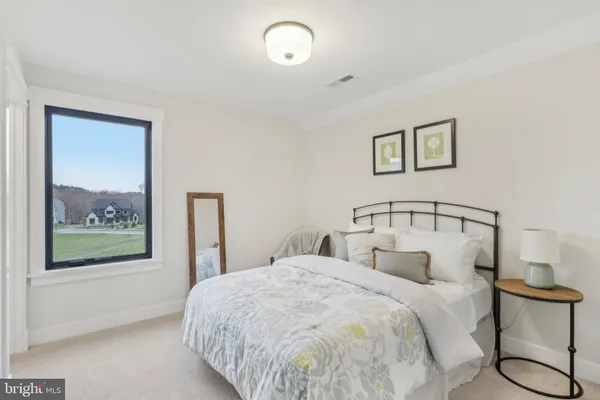 a bedroom with a large bed and a window