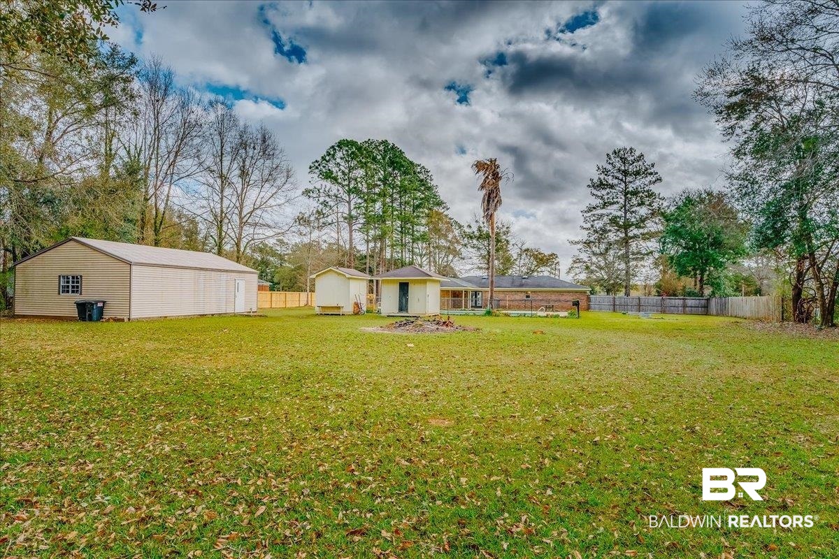 440 Dykes Road Mobile, AL 36608 - Photo 37 of 49 View of yard with an outdoor structure and fence