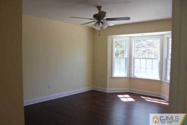4 Herron Road Edison, NJ 08820 - Photo 15 of 25 an empty room with wooden floor fan and windows