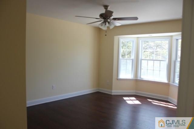 4 Herron Road Edison, NJ 08820 - Photo 16 of 25 a view of an empty room with wooden floor and a window