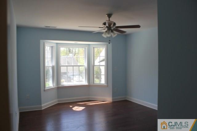 4 Herron Road Edison, NJ 08820 - Photo 17 of 25 a view of an empty room with wooden floor and window