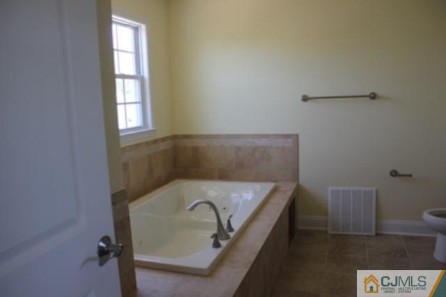 4 Herron Road Edison, NJ 08820 - Photo 20 of 25 a bathroom with a bathtub