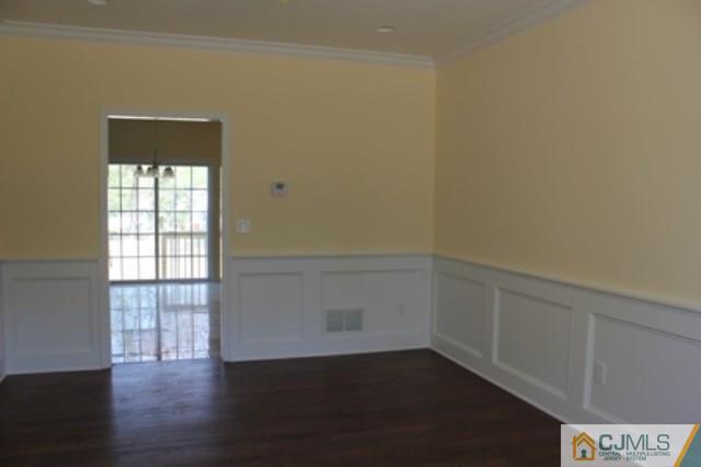 4 Herron Road Edison, NJ 08820 - Photo 3 of 25 an empty room with wooden floor and windows