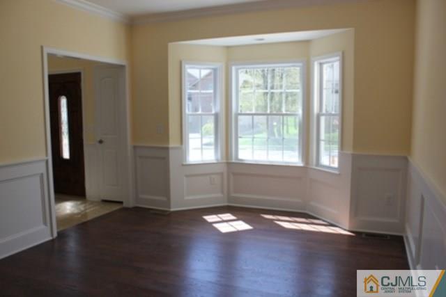 4 Herron Road Edison, NJ 08820 - Photo 4 of 25 an empty room with wooden floor and windows