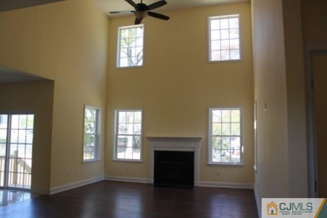 4 Herron Road Edison, NJ 08820 - Photo 5 of 25 a view of an empty room with a window and wooden floor