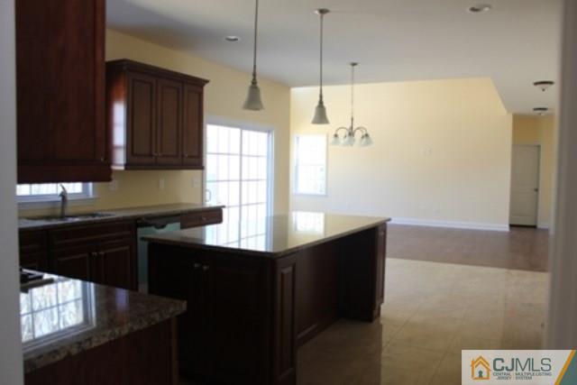 4 Herron Road Edison, NJ 08820 - Photo 6 of 25 a kitchen with stainless steel appliances granite countertop a sink a stove and a refrigerator