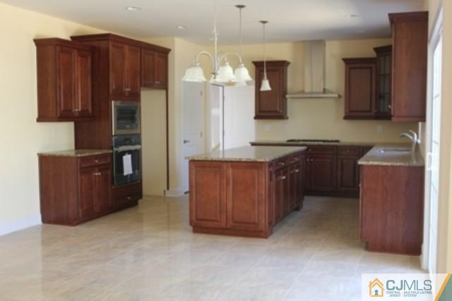 4 Herron Road Edison, NJ 08820 - Photo 9 of 25 a kitchen with a sink and a refrigerator