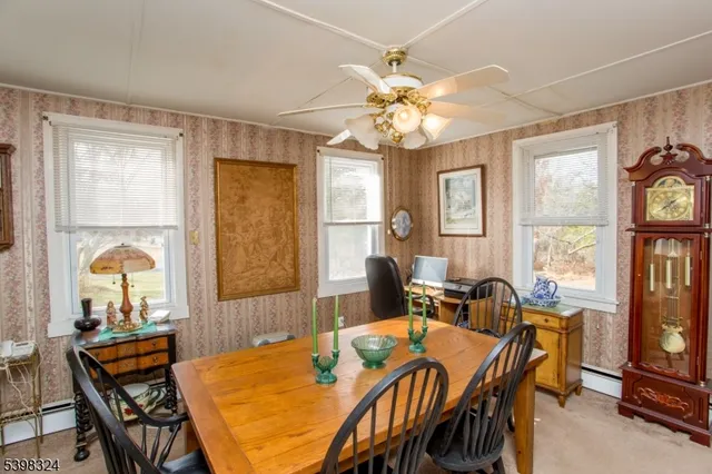 a view of a dining room with furniture and chandelier