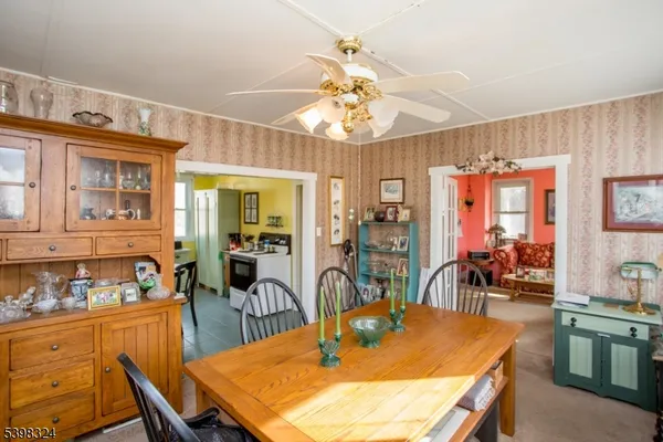 a kitchen with a sink a window and chairs