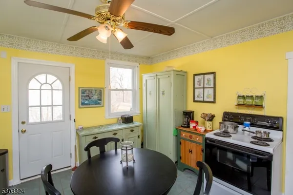 a dining room with stainless steel appliances furniture stove and refrigerator