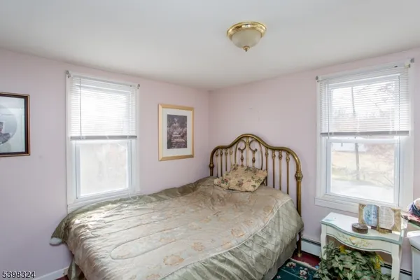 a bedroom with furniture and a window