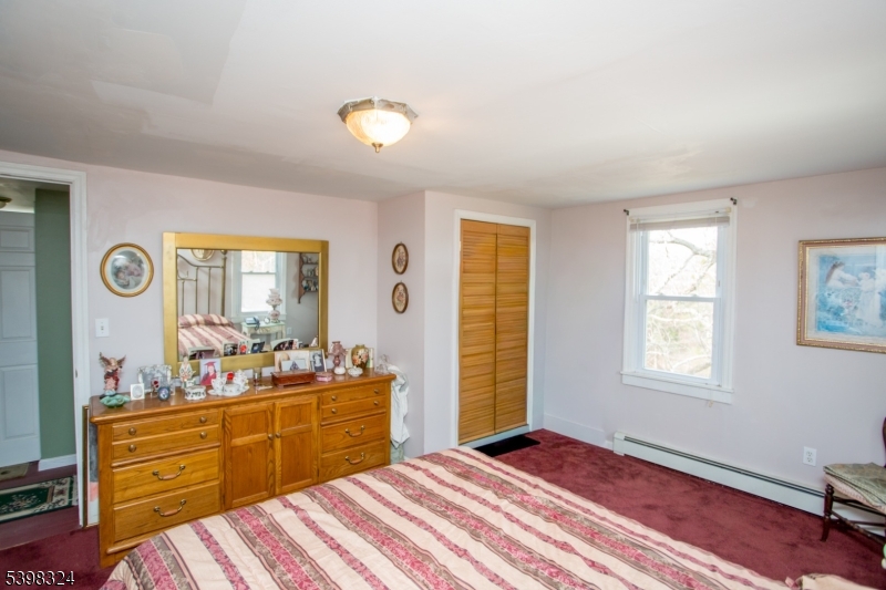47 Hewitt Road Stockton, NJ 08559 - Photo 28 of 31 a bedroom with a bed and wooden floor