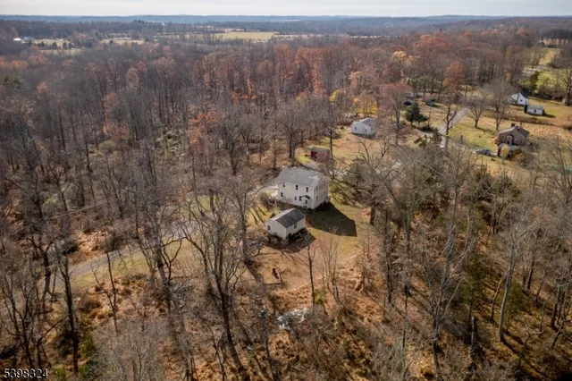 a front view of a house with a yard covered with snow