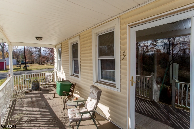 47 Hewitt Road Stockton, NJ 08559 - Photo 9 of 31 a balcony with furniture and a potted plant