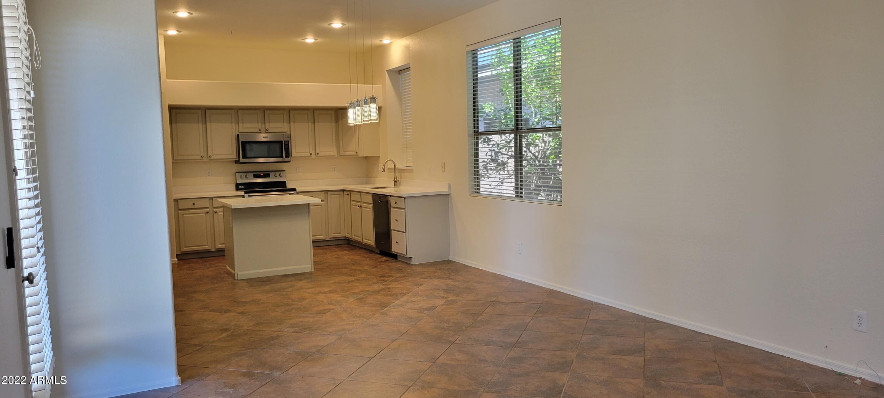 7323 East Overlook Drive Scottsdale, AZ 85255 - Photo 12 of 28 a view of a kitchen with a sink and dishwasher a refrigerator with wooden floor