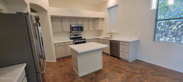 a kitchen with stainless steel appliances a refrigerator stove and sink