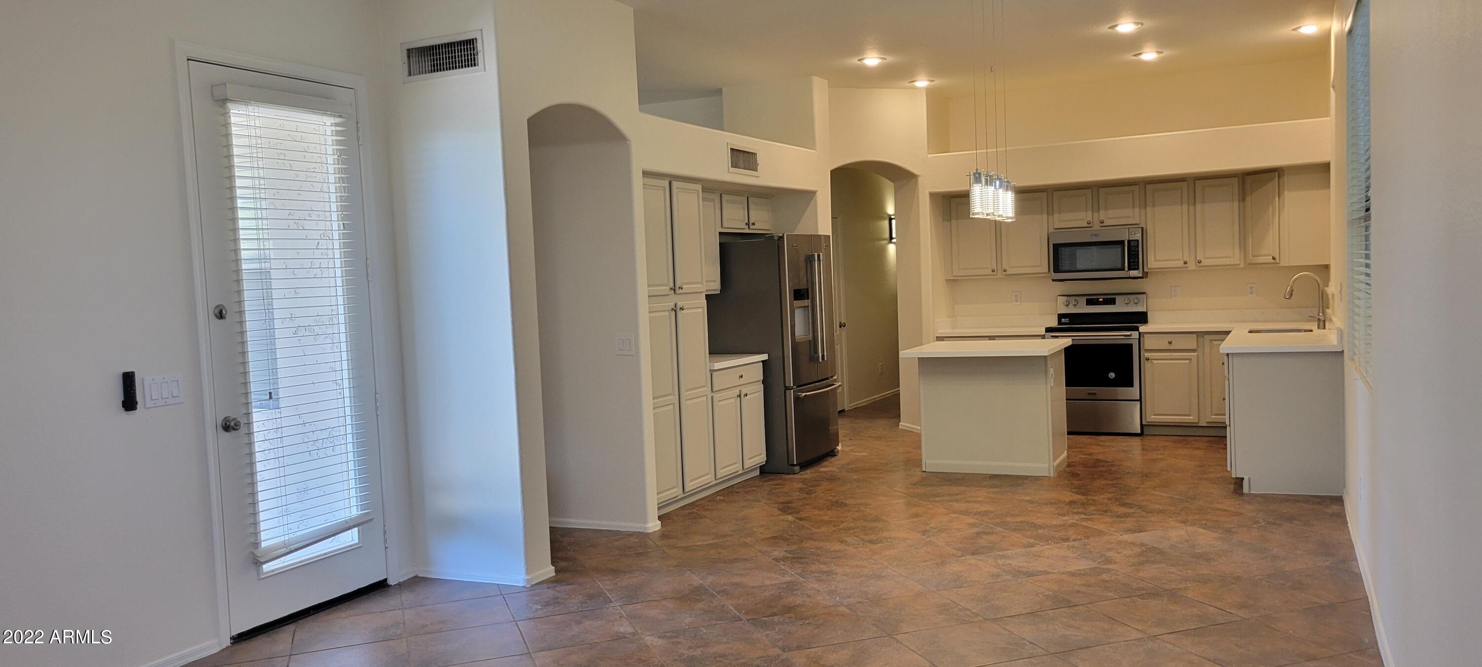 7323 East Overlook Drive Scottsdale, AZ 85255 - Photo 9 of 28 a kitchen with stainless steel appliances granite countertop a refrigerator and a sink