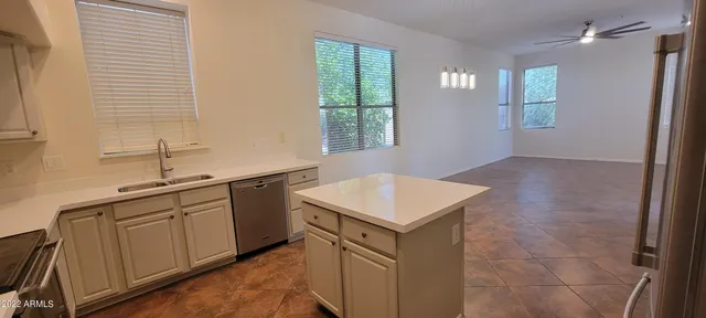 a kitchen with a sink cabinets and window