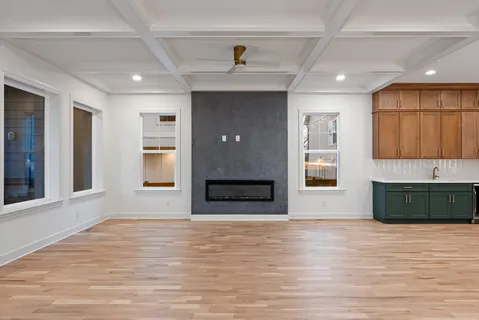 a kitchen with a sink cabinets and wooden floor