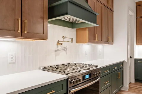 a view of an empty room with a fireplace and wooden floor