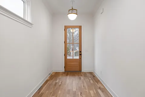 a kitchen with stainless steel appliances granite countertop a sink a stove and a refrigerator