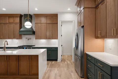 a view of a kitchen with a sink and a refrigerator