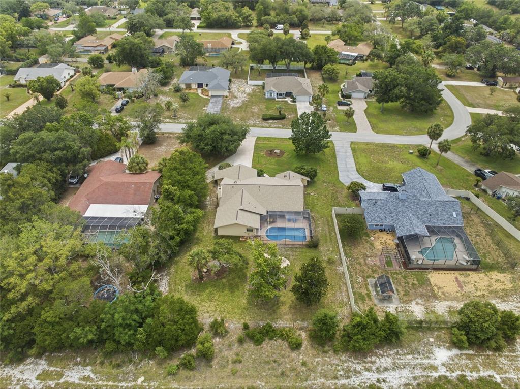 5227 Suwannee Road Weeki Wachee, FL 34607 - Photo 59 of 62 an aerial view of residential houses with outdoor space and swimming pool