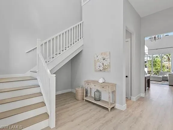 a view of entryway with stairs and wooden floor