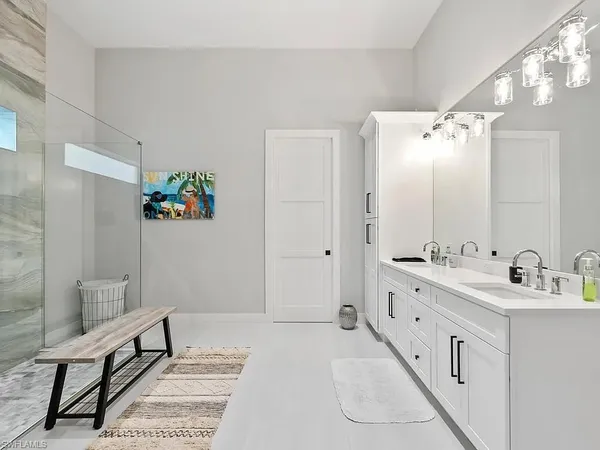a spacious bathroom with a double vanity sink a mirror and a bathtub