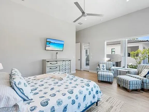a bedroom with a bed a couch and a window