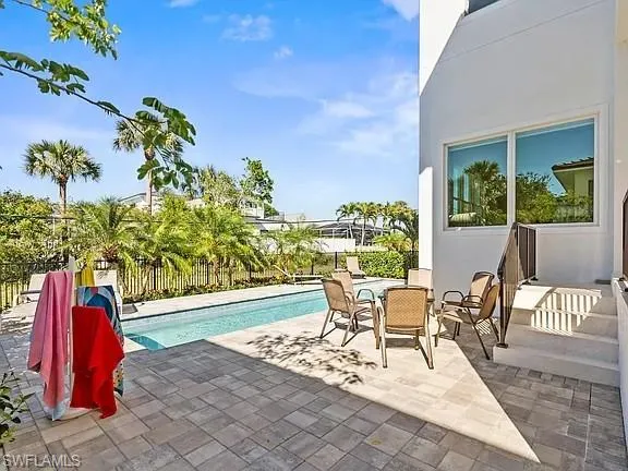 a view of a two chairs and table in patio