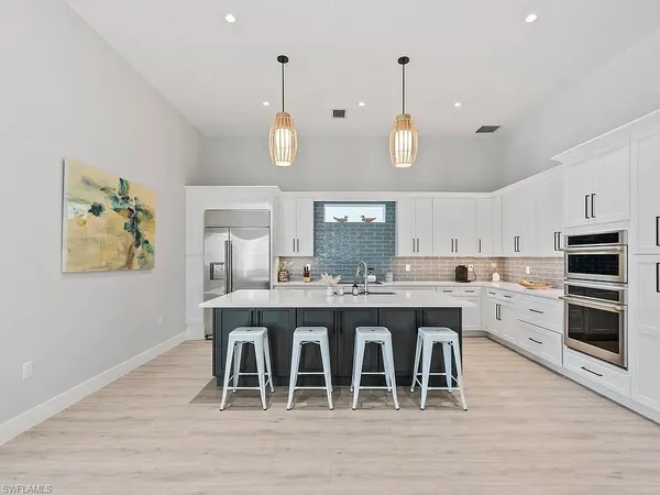 a large kitchen with a table and chairs in it