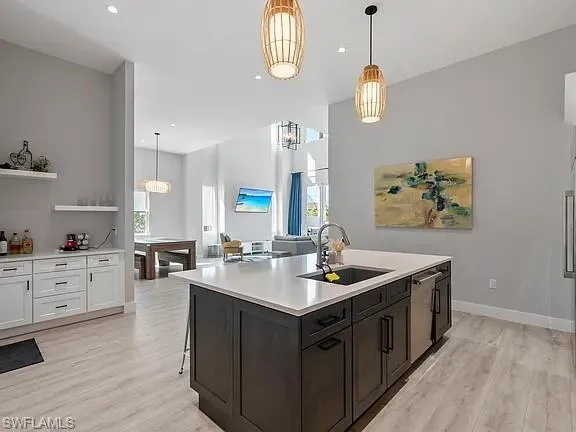 a kitchen with sink stove and cabinets