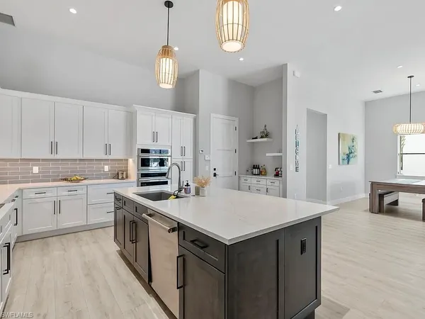 a kitchen with a stove a sink and a refrigerator